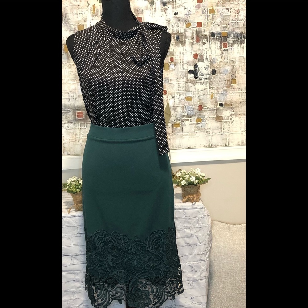 Tiffany and Grey black and white polka dot sleeveless blouse with side bow tie.